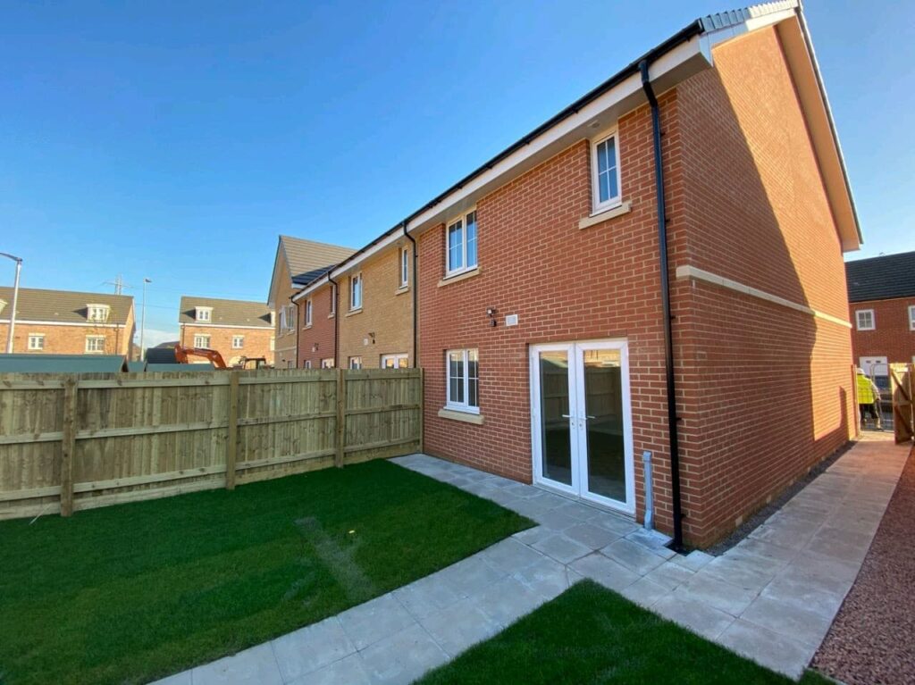 Image shows a house and garden